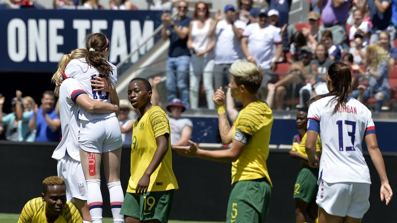 The United States team celebrates after a goal by midfielder Samantha Mewis (3) in the first...