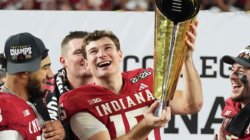 Indiana quarterback Fernando Mendoza (15) holds the trophy after Indiana defeated Miami in a...