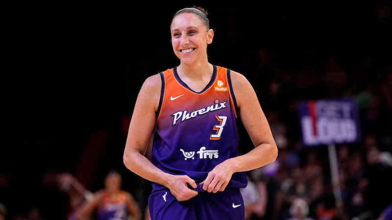 FILE - Phoenix Mercury's Diana Taurasi smiles during the second half of a WNBA basketball game...