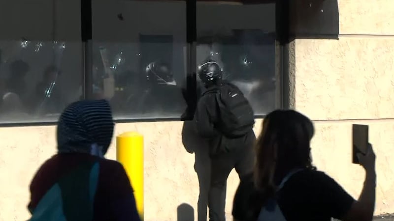 During the protest near the ICE office on Country Club Road, protesters were seen breaking...