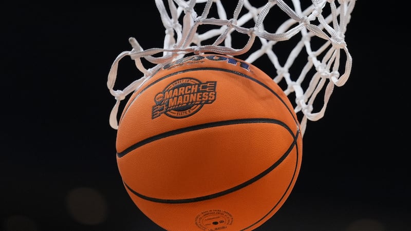 FILE - A basketball goes throw the net before an Elite Eight game between Iowa and Illinois in...